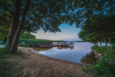 Jezioro Ostrowieckie, Poland - July 2020 : Private Boat landing and pier on a boat on Jezioro Ostrowieckieのeditorial素材