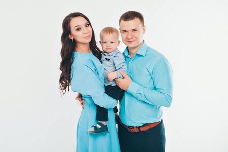 baby on the hands of parents on a white background.の写真素材