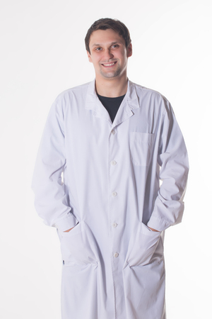 a man in a white robe. smiling doctor on white backgroundの写真素材
