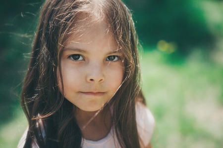 Portrait of a girl on a background of green foliage