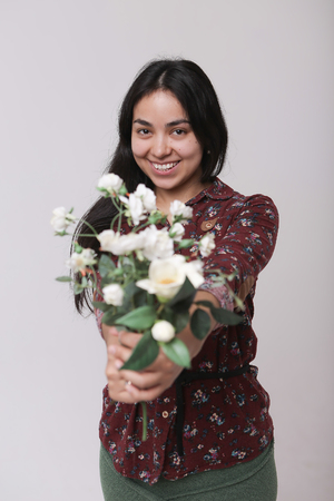 Portrait of a woman with flowers on white backgroundの写真素材