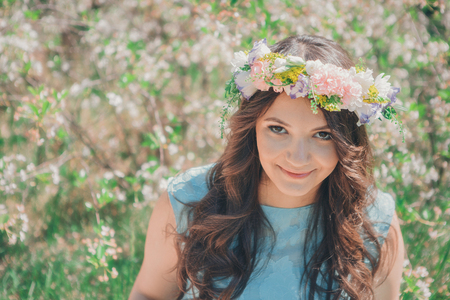 Portrait of a girl on a background of green foliageの写真素材