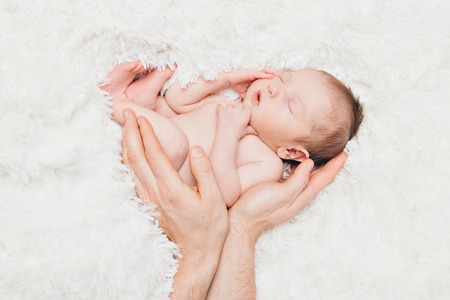 Portrait of newborn baby on a white background.の写真素材