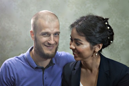 portrait of a man and a woman on a grey background. Pair in blue