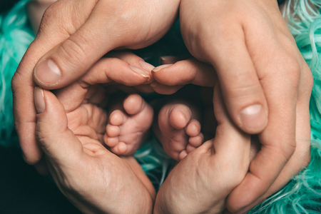 baby feet close up on green backgroundの写真素材