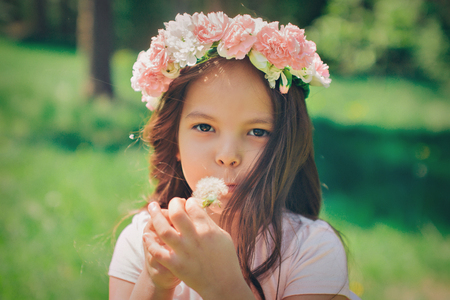 Portrait of a girl on a background of green foliageの写真素材