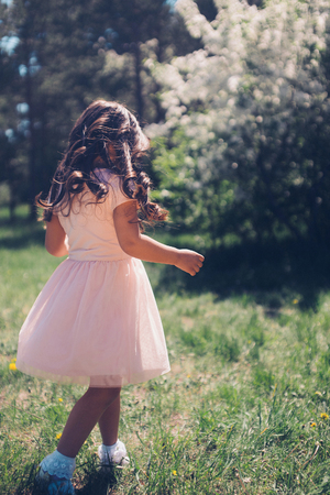Portrait of a girl on a background of green foliageの写真素材