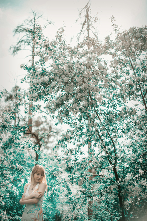 young woman in forest on a background of green foliageの写真素材