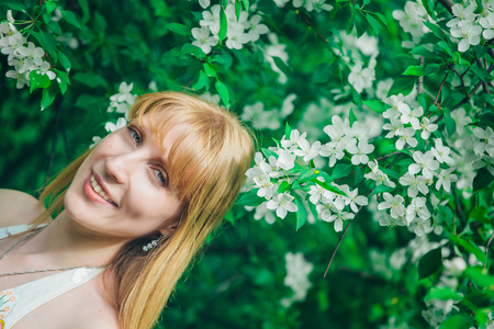 Portrait of a girl on a background of green foliageの写真素材