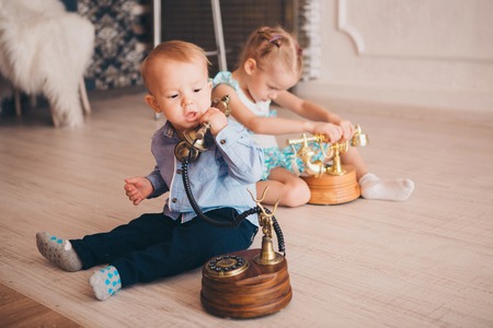 Children play with the phone on the floor. Business concept for beginners. Job interview. business negotiationの写真素材