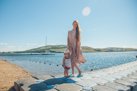 Portrait of a woman with child on a background of sea. Travel to seaの写真素材