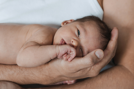 a baby on the hands of parentsの写真素材