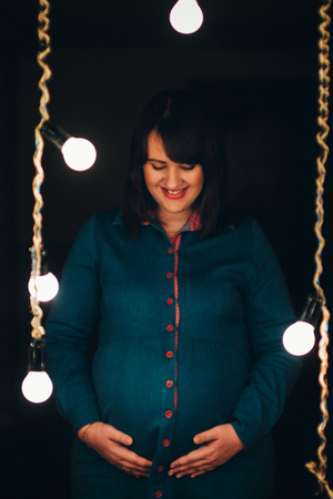 pregnant woman on a lamps background. Fashion for pregnantsの写真素材