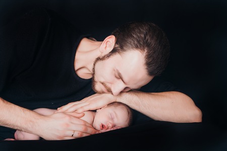 A men with baby on a balck backgroundの写真素材