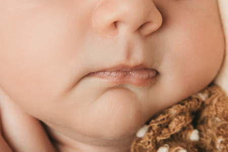 portrait of newborn baby. nose and lips close upの写真素材