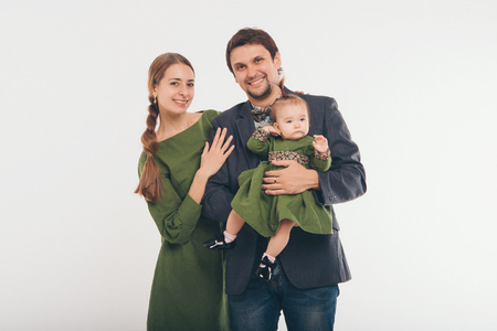 Family photo: mom, dad, child. Fashion in green and greyの写真素材