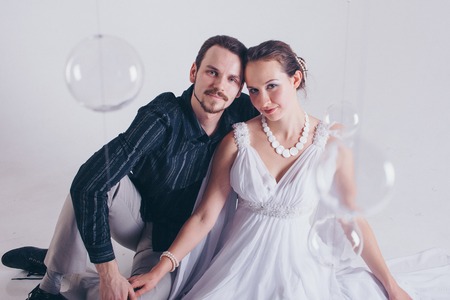 portrait of a man and a woman on a white background. Pair in suit and dressの写真素材