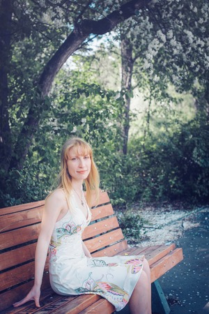 Portrait of a girl on a background of green foliageの写真素材