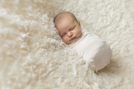 Portrait of newborn baby on a white background.の写真素材