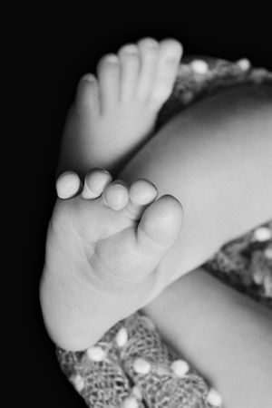 baby feet in parents ' hands closeup in balck background: the hygiene, diseases of the feet, the fungus, pedicureの写真素材