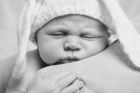 portrait of newborn baby in a hat with ears. Newborn fashionの写真素材