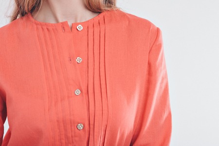 cropped photo: close-up of clothing items: red shirtの写真素材