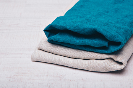 rolled up clothes made of natural fabric on white background. Elements of clothing close-upの写真素材