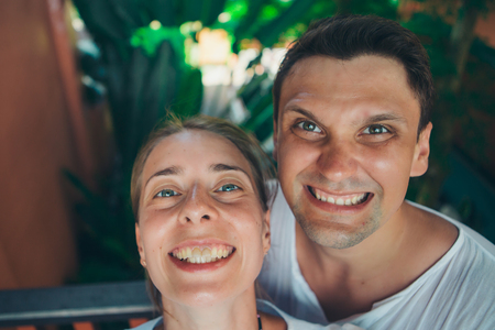Portrait of a woman and a man: takes a selfie on the beach. Girl and boy on vacation. Couple and husband and wifeの写真素材