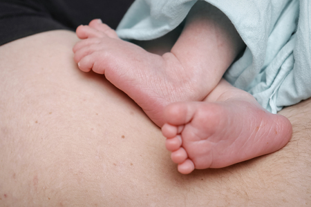 baby feet close up in balck background. Advertising of hygiene, foot diseases, fungus, pedicure, orthopedicsの写真素材