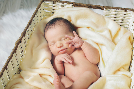 A little child lies in the basketの写真素材