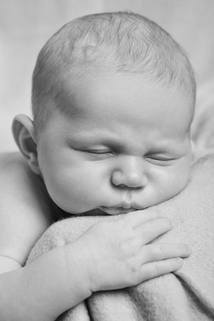 portrait of newborn baby lying on the hands of parents. the concept of newborn healthの写真素材