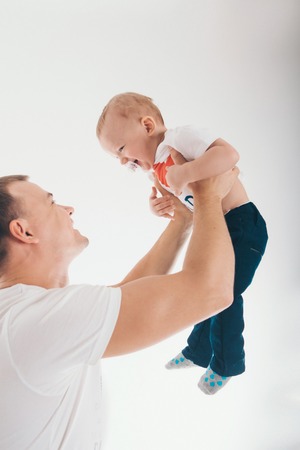 dad holds his son in his arms. the man and the childの写真素材