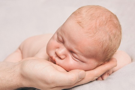 portrait of newborn baby lying on the hands of parentsの写真素材