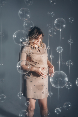 a pregnant woman holding hands on bellyの写真素材