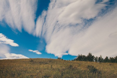Beautiful landscape on lowlands with nice sky with white fluffy clouds. Backlit landscape...