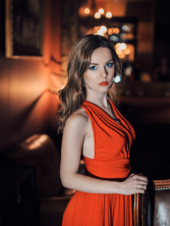 beautiful girl in long red dress standingの写真素材