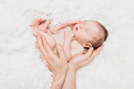 Portrait of newborn baby on a white background.の写真素材