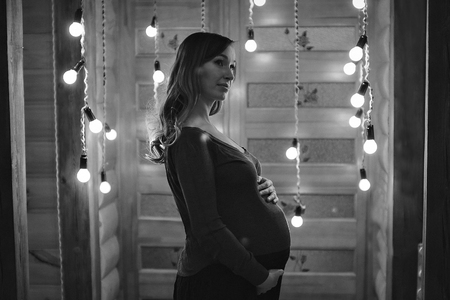 silhouette of Pregnant woman on a lamps backgroundの写真素材