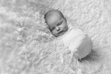 A little child in a diaper lies and sleepingの写真素材