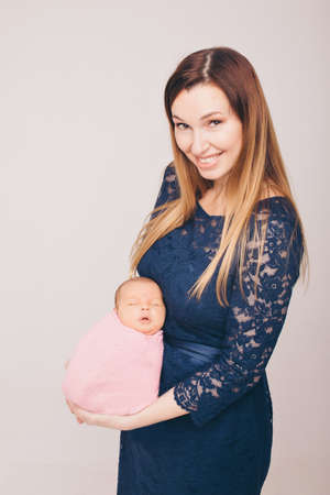 baby on the hands of mother. woman and childの写真素材