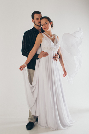 portrait of a man and a woman on a white background. Pair in suit and dressの写真素材