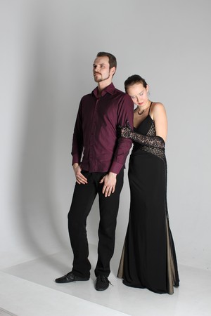 portrait: man in suit and woman in dress on white background. The bride and groom in an isolated photo. Husband and wife face to faceの写真素材
