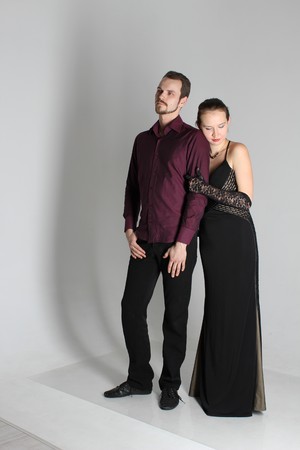 portrait: man in suit and woman in dress on white background. The bride and groom in an isolated photo. Husband and wife face to faceの写真素材
