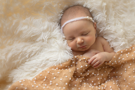Portrait of newborn baby on a white background.の写真素材