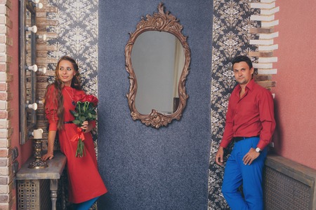 portrait of a man and a woman. Pair in red and blueの写真素材
