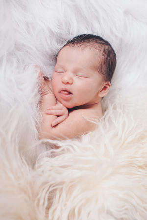 Portrait of newborn baby on a white background.の写真素材