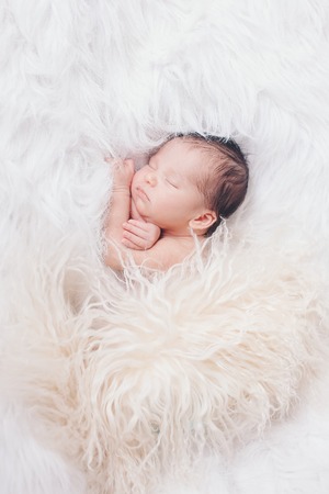 Portrait of newborn baby on a white background.の写真素材