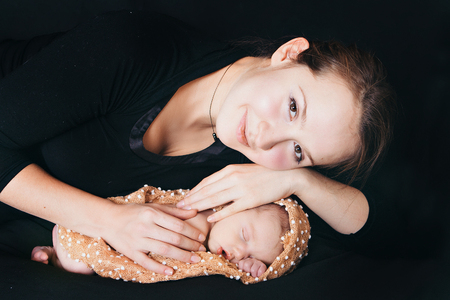A women with baby on a balck backgroundの写真素材