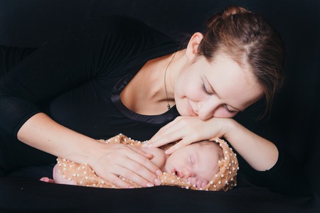 A women with baby on a balck backgroundの写真素材