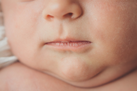 portrait of newborn baby. nose and lips close upの写真素材